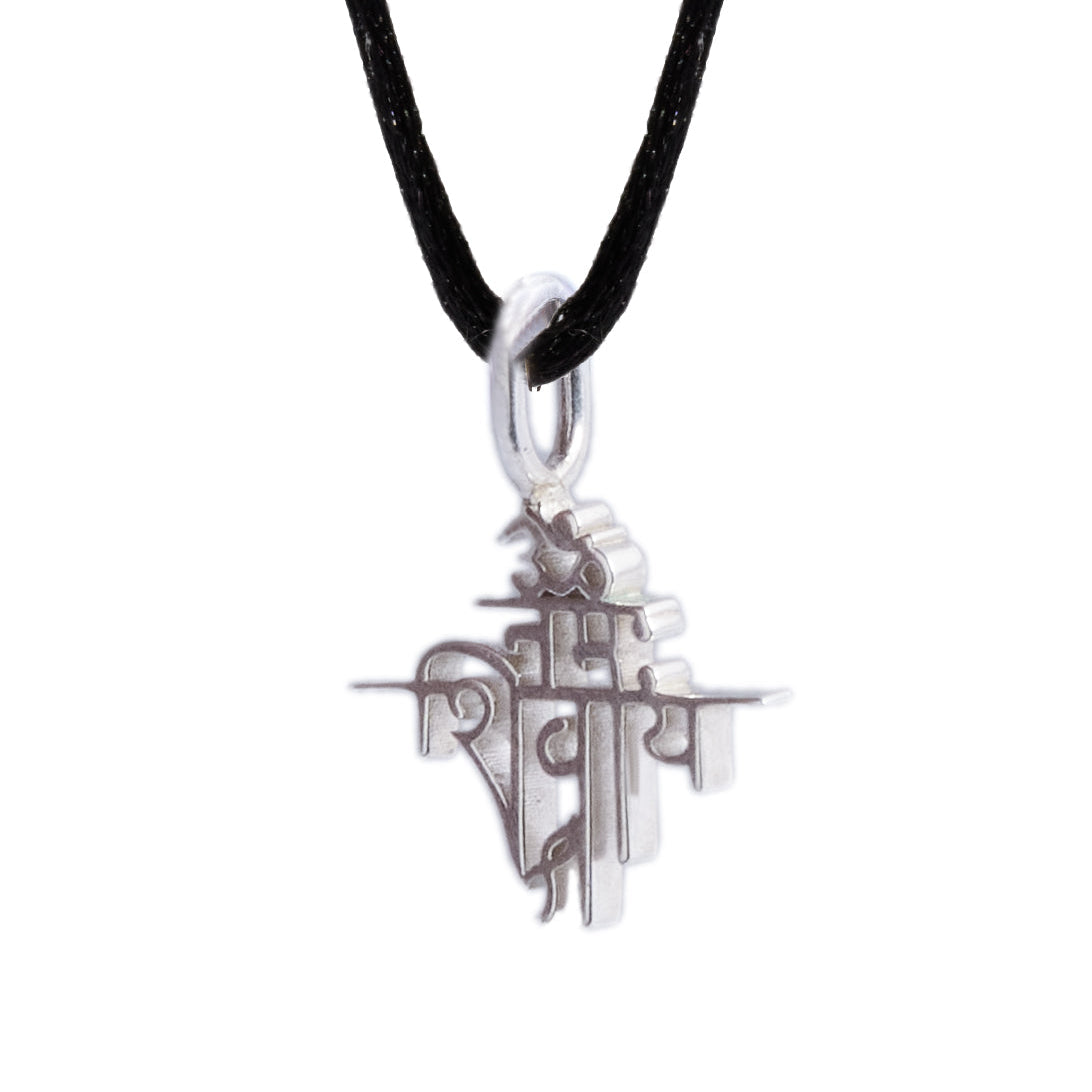 Silver pendant on a black cord against a white background